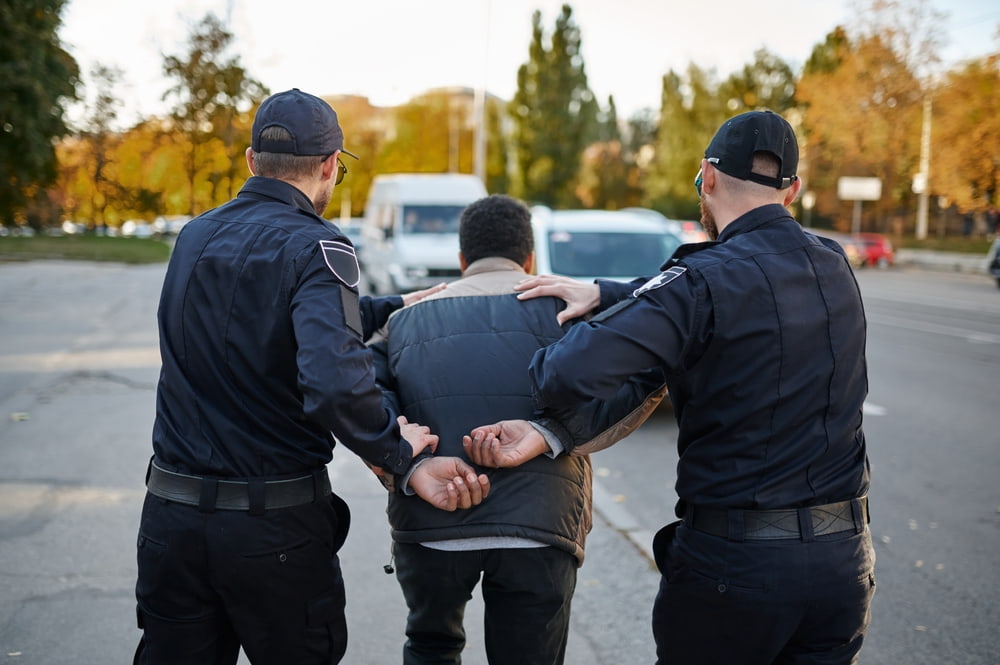 Police officers arresting young person