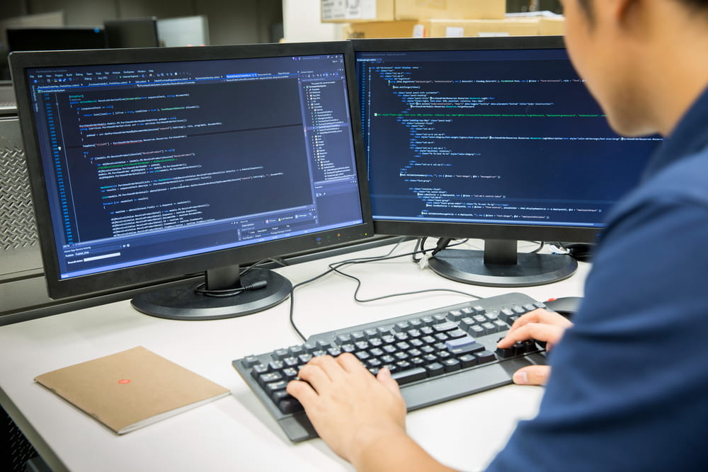 Programmer working on a desktop computer